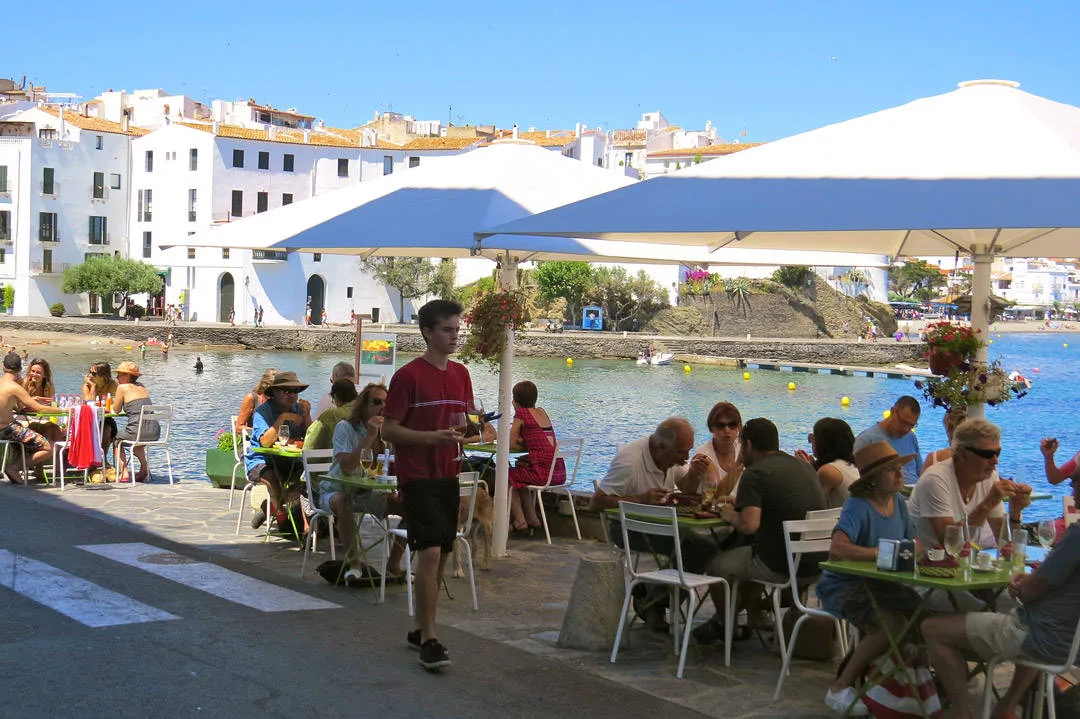 Stripa med Es Cau, L'estable og flere restauranter på rad og rekke. Herlig utsikt utover vannet og byen.