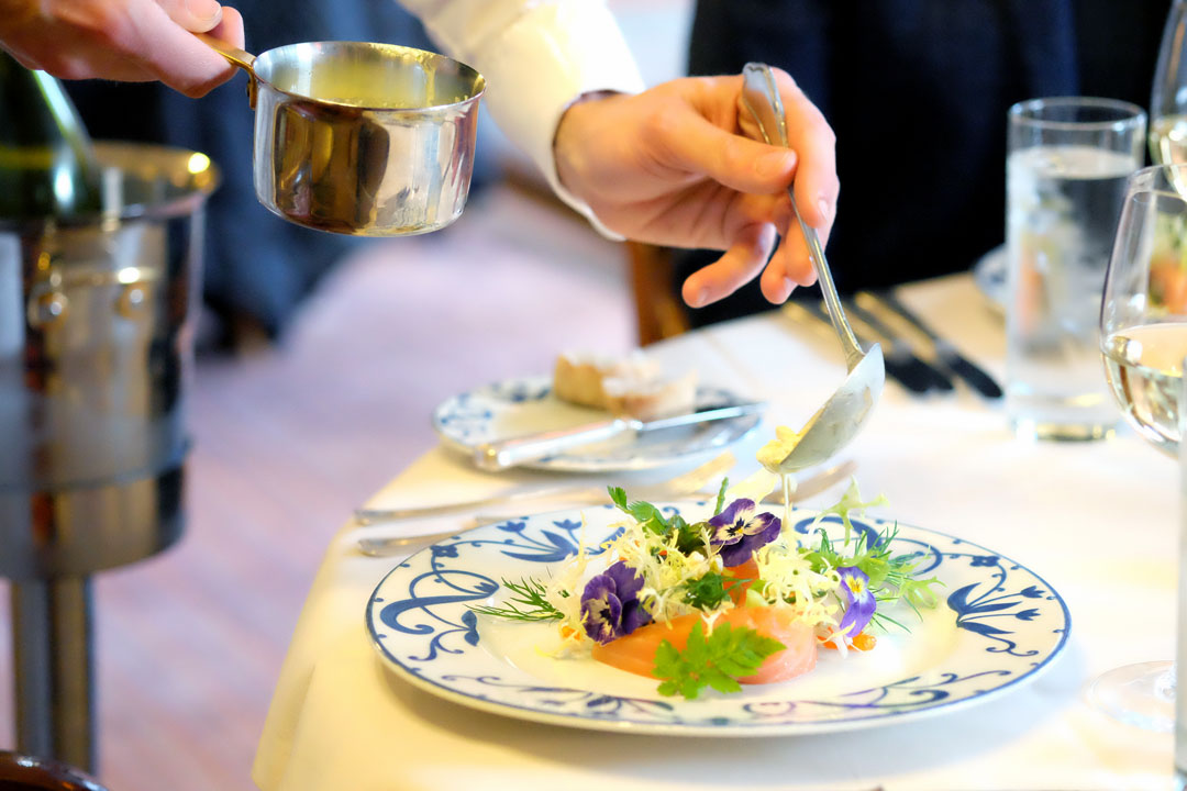 Røkt laks, rogn, argurk, rygeost, brødkrutonger og persilleolje.